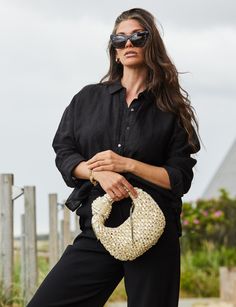 This hobo bag is woven from raffia and then hand embroidered with over 100 faux baroque pearls and trimmed in metallic leather. The knotted bow accent is fun and feminine, while still being elevated and modern. Stow your phone and keys inside and slip it over your wrist for easy carrying. VOGUE calls The Josie Knot Bag one of "The Very Best Raffia Bags to Carry You Through the Summer in Style." POOLSIDE bags are handwoven by female artisans in The Philippines, India, Morocco, and Spain, using na Summer Chic Hobo Bag With Round Handle, Chic Summer Hobo Bag With Round Handle, Chic Hobo Bag With Bamboo Handle, Elegant Summer Hobo Bag, Elegant Woven Hobo Bag For Vacation, Elegant Summer Hobo Bag With Top Handle, Chic Handwoven Shoulder Bag, Chic Evening Hobo Bag With Braided Handles, Elegant Straw Bag For Day Out