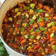 a pot filled with stew and vegetables on top of a table