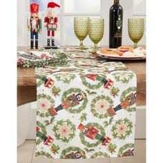 a table topped with christmas decorations and wine glasses