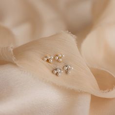 Our Pearl Cluster Drop Studs are the perfect wedding accessory for brides who adore a blend of elegance and ease. Whether you're walking down the aisle or dancing the night away, these earrings add a touch of timeless charm to any wedding look, ensuring you feel extra beautiful on your special day ♡ SKU: RR-ER497 Product Details Material: High Quality Solid 925 Sterling Silver Finish: 18K Gold ∙ Sterling Silver Featuring ~6x6.5mm Stud Earrings with a ~3x6.5mm Trio Pearl Bar and ~3.5x2mm Pearl Da Delicate Pearl Earrings For Evening, Elegant Bridal Accessories For Anniversary, Elegant Ear Climbers For Party, Dainty Sterling Silver Ear Climbers For Wedding, Delicate Pearl White Earrings For Evening, Delicate Pearl White Evening Earrings, Delicate Pearl White Pearl Earrings For Evening, Pearl White Delicate Earrings For Evening, Elegant Single Ear Climber For Parties