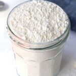 a glass jar filled with white powder sitting on top of a table