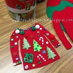 two red christmas sweaters with green trees and candy canes next to a can