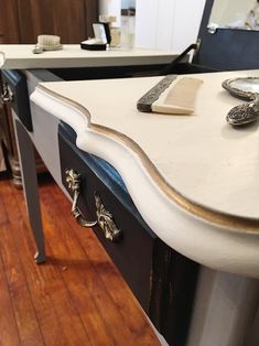 a white counter top sitting on top of a hard wood floor next to a mirror