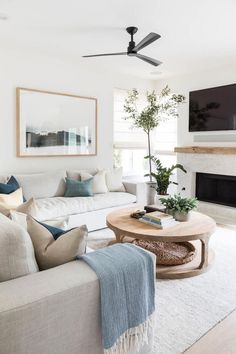 a living room filled with furniture and a flat screen tv mounted on the wall above a fireplace