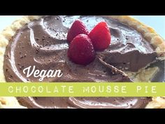 a chocolate mousse pie with three strawberries on top and the words vegan above it