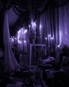 a living room filled with furniture and lots of candles in the dark night time light