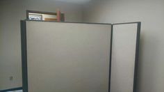 an empty room with two partitions in it