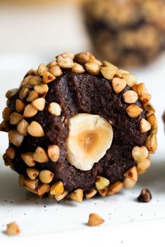 there is a chocolate cookie with nuts on top and a banana in the middle that has been cut into pieces