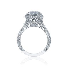 an oval cut diamond engagement ring with double halos on the shoulders and side stones