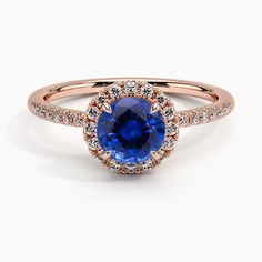 an oval blue sapphire and diamond halo engagement ring