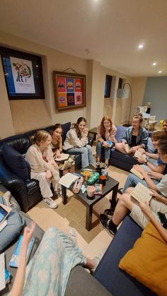 a group of people sitting on couches in a living room next to each other