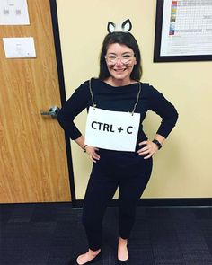 a woman dressed as a cat with glasses and a sign that says ctrl + c