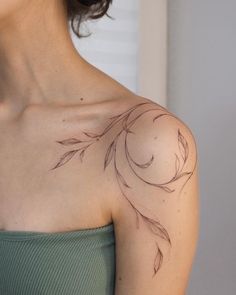 a woman with a tattoo on her shoulder