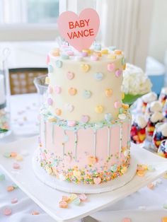 there is a cake that has been decorated with confetti and hearts on it