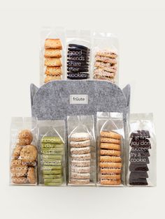 an assortment of donuts and pastries in clear plastic bags on a white background