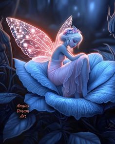 a fairy sitting on top of a blue flower