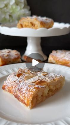 a white plate topped with pastry on top of a cake stand next to other desserts