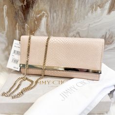 This Jimmy Choo Clutch Bag Is A Stunning Addition To Any Outfit. The Exterior Is Made Of High-Quality Leather In A Beautiful Pink Snakeskin Pattern. The Chain Strap Adds A Touch Of Elegance And Can Be Worn Over The Shoulder Or As A Clutch. Stunning Authentic Jimmy Choo Milla Clutch Light Pink Iridescent Snakeskin Leather With Thick Gold Chain Accent. Snap Front Closure Comes With Dustbag Excellent Condition - Comes With Duster And Tag Attached. Some Scratches Lightly If You Zoom Just From Storin Luxury Pink Leather Clutch, Designer Blush Bags For Formal Occasions, Pink Clutch With Chain Strap For Formal Occasions, Formal Pink Clutch With Chain Strap, Luxury Blush Bag, Luxury Blush Bags, Luxury Blush Formal Bags, Designer Clutch With Chain Strap, Pink Luxury Evening Bag With Gold-tone Hardware