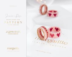 two pink bracelets sitting next to each other on top of a white tablecloth