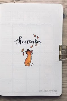 a notebook with the words september written on it and an image of a dog's head