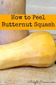 a squash sitting on top of a wooden table next to a jar of peanut butter