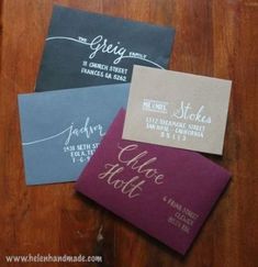 three different colored envelopes with the names of their wedding and date printed on them