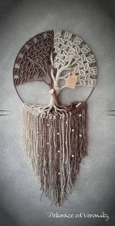 the tree of life is made with yarn and wood, it has a tag attached to it