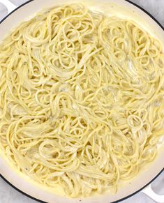 a pan filled with noodles and sauce on top of a table