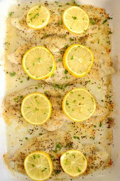 chicken with lemons and herbs in a baking dish