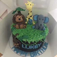 a birthday cake with animals and giraffes on it