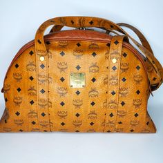 Pre-Loved Authentic Vintage Mcm Cognac Shoulder Bag- Will Pass Through Poshmark Concierge Authenticity For Free If Purchased For $500+ Metal Plate Engraved 5234f (The Name Of The First Owner Engrave “Megumi”) Ykk Zipper Closures, Logo Has Uneven Number Of Leaves On Each Side And The Logo Goes In Rows Of Right Side Up And Right Side Down, All Heat Marks Are Seen Inside And On Outer End As Expected, Engraving Plate Has Id Number In Correct Font/Size/Format. (Passes Authenticity Check) Made In Germ Engraved Plates, Mcm Bags, Ykk Zipper, Metal Plate, Font Size, Right Side, Cognac, The Row, Shoulder Strap