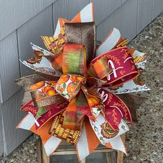 Large Fall or Thanksgiving Funky Bow For Lantern, Thankful Bow, Fall Wreath Bow, Lamp Post Bow, Wreath Attachment, Door Hanger Bow, Garden Flage Pole, Decorative Flag Pole This Fall bow is the perfect accent for your Fall and Thanksgiving decor.  It is made with 9 different ribbons, one 4" ribbon, four 2.5" ribbons, and four 1.5" ribbons in various colors and patterns.  It is approximately 12" L X 12" W X 6" D.  My bows are handmade and secured with a zip tie.  A chenille stem has also been adde Fall Bows For Wreath, Fall Wreath With Bow, Turkey Wreath Attachments, Lantern Bows, Fall Ribbon Bows, Blue Fall Decor, Funky Bow, Spring Burlap Wreath, Tropical Wreath