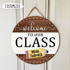 a wooden sign that says welcome to our class with candy bar in front of it