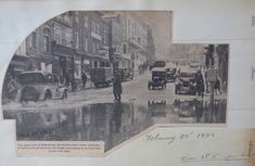 an old photo of people and cars on the street in front of buildings with water puddles