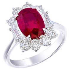 Introducing the Certified 3.08 Carat Pigeon's Blood Ruby and Diamond Ring, a masterpiece of distinctive design and luxury. At its center is a stunning 3.08-carat Pigeon's Blood ruby, renowned for its vivid, deep red hue—the most prized color for rubies. Certified for its exceptional quality, this rare gemstone radiates unmatched beauty and allure. What makes this ring truly unique is its non-traditional mounting, which forgoes the classic three-stone layout. The ruby is beautifully framed by spa Blood Ruby, Ruby Diamond Ring, Ruby And Diamond Ring, Ruby Diamond Rings, Diamond Halo Ring, Rare Gemstones, Halo Diamond Ring, Ruby Diamond, Halo Ring