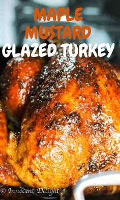 a close up of a cooked turkey in a pan with the words maple mustard glazed turkey