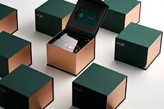 an open box with a watch inside surrounded by other boxes