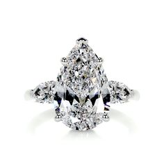 an oval cut diamond ring with pear shaped diamonds