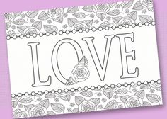 a card with the word love written in black and white on it, surrounded by flowers