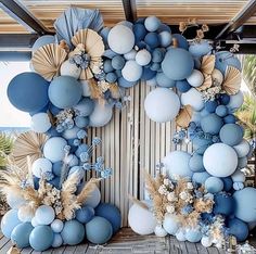 a bunch of balloons that are hanging on a wall in the shape of a wreath