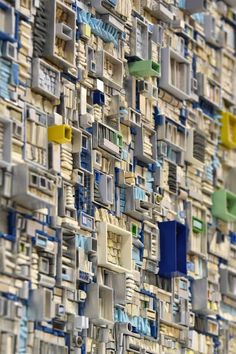 an abstract wall made up of many different types of windows and doors in various colors