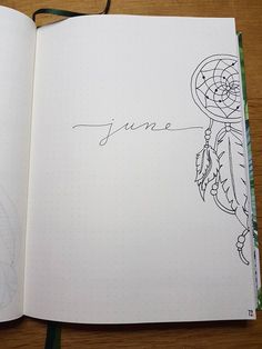 an open notebook with the word june written in cursive writing and a drawing of a dream catcher