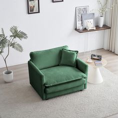 a green chair sitting on top of a white rug next to a potted plant