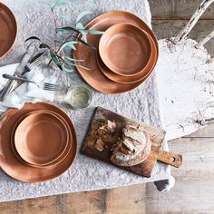 a table topped with plates and bowls filled with food