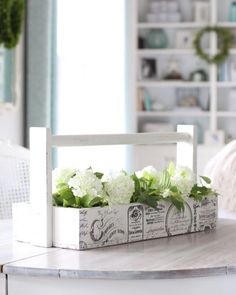 a diy toolbox with flowers in it sitting on top of a white table