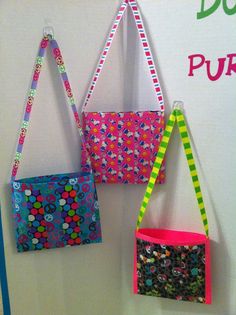 three purses are hanging on the wall