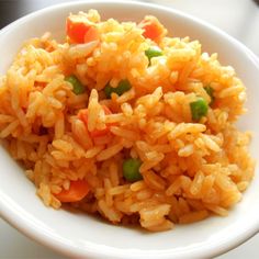 a white bowl filled with rice and vegetables