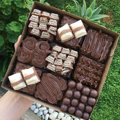 a box filled with lots of different types of chocolates and marshmallows