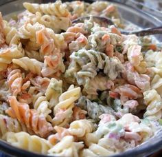 a bowl filled with pasta salad on top of a table