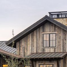 a wooden house with metal roof and windows